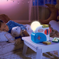 Child sleeping with a teddy bear next to a Little Tikes night light in a cozy bedroom.