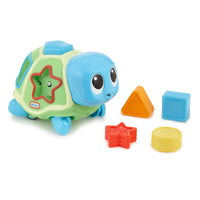 Toy turtle with shape sorting blocks on a white background