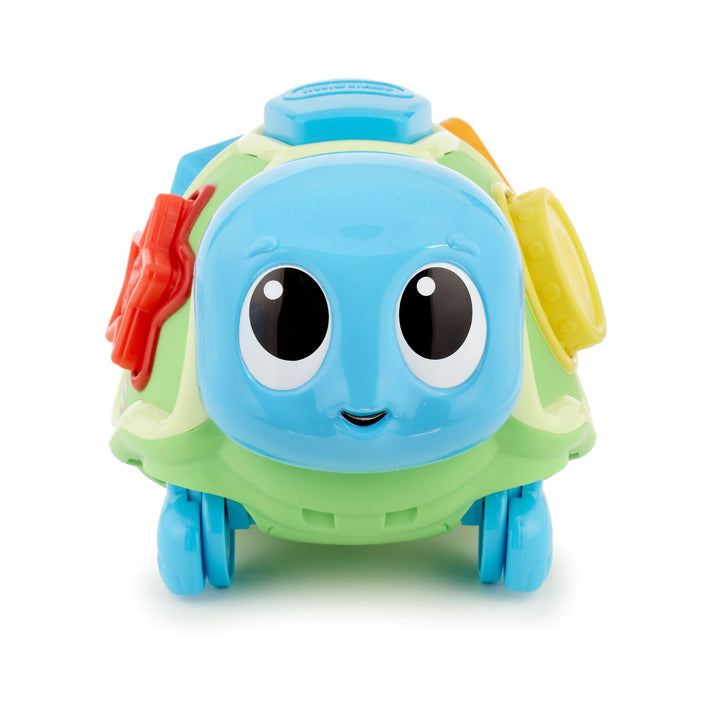 Colorful toy turtle with a smiling face on a white background