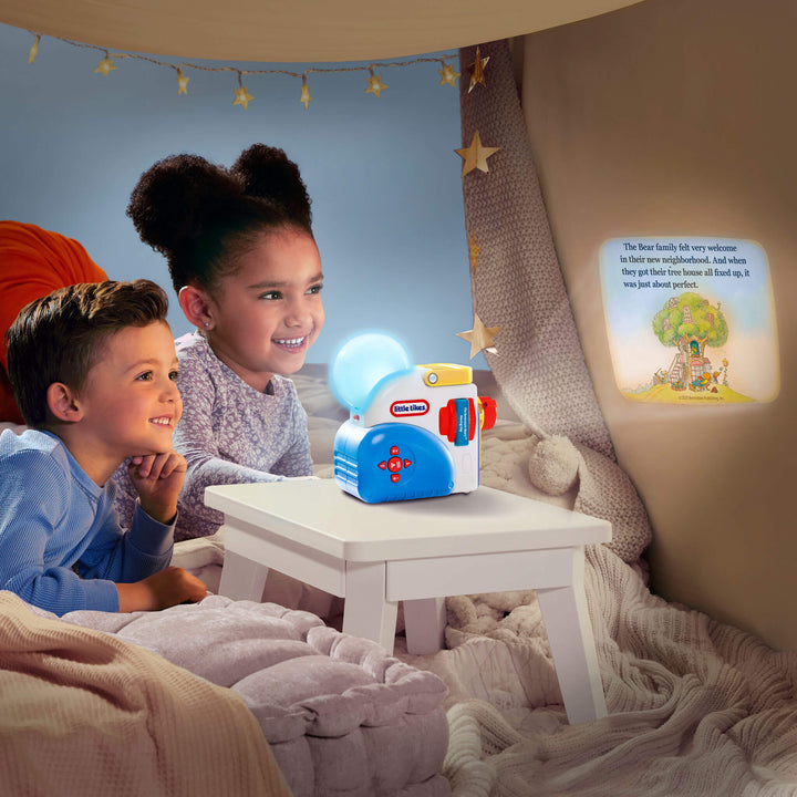 Two children sitting in a cozy room with a night light and children's book projected on the wall.