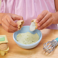 Girl "breaking" a pretend egg