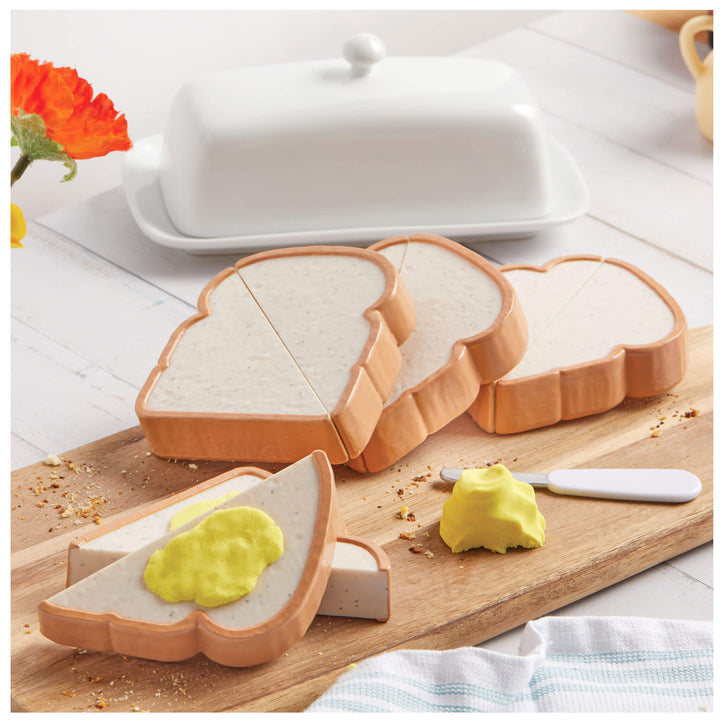 Cutting board with slices of bread on a wooden surface.