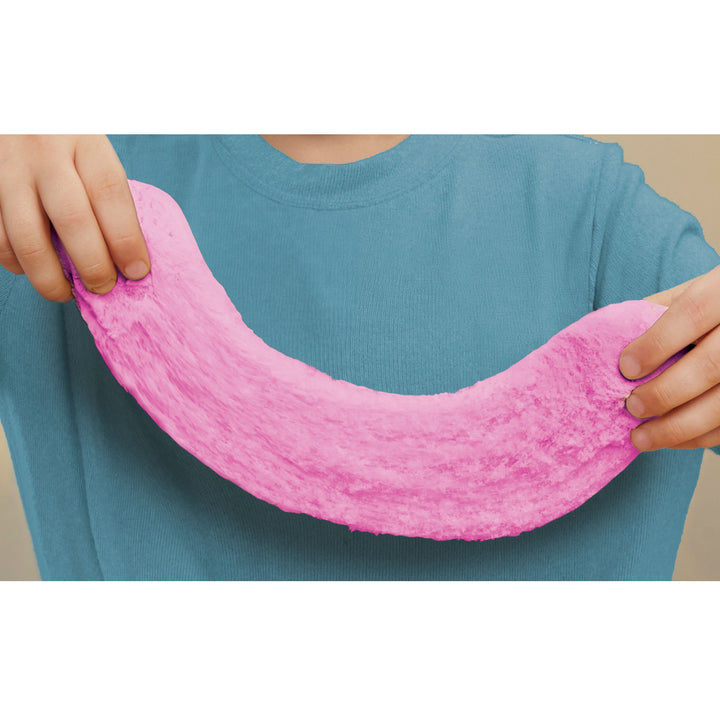 Boy holding a large piece of the  strawberry dough