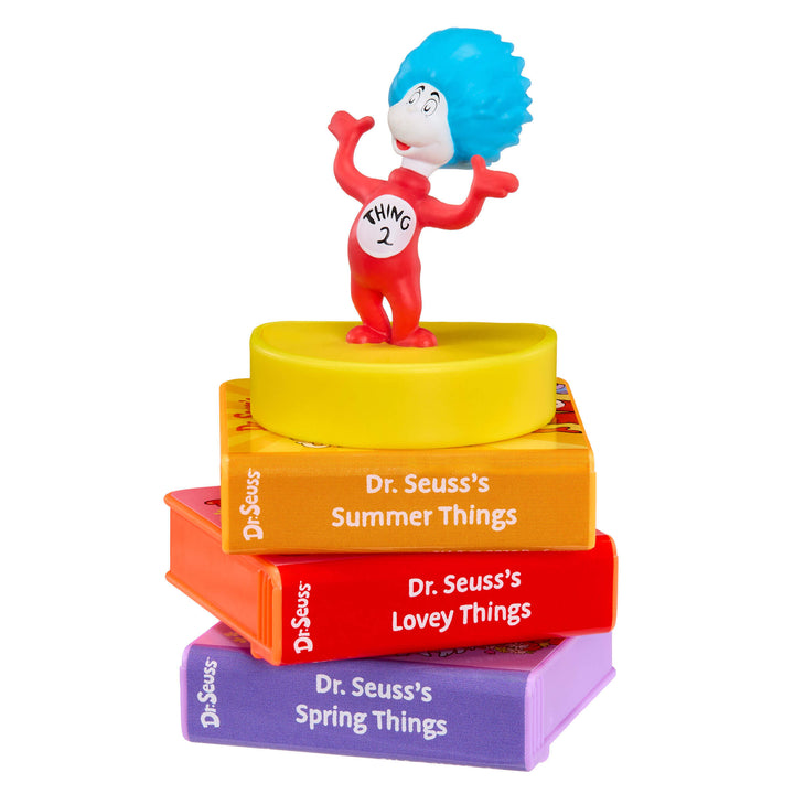 Thing Two Toy figure on top of stacked books with 'Dr. Seuss' titles