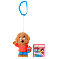 Toy figure of a bear character with a blue keychain and a book titled 'The Berenstain Bears and the Bad Dream' on a white background.