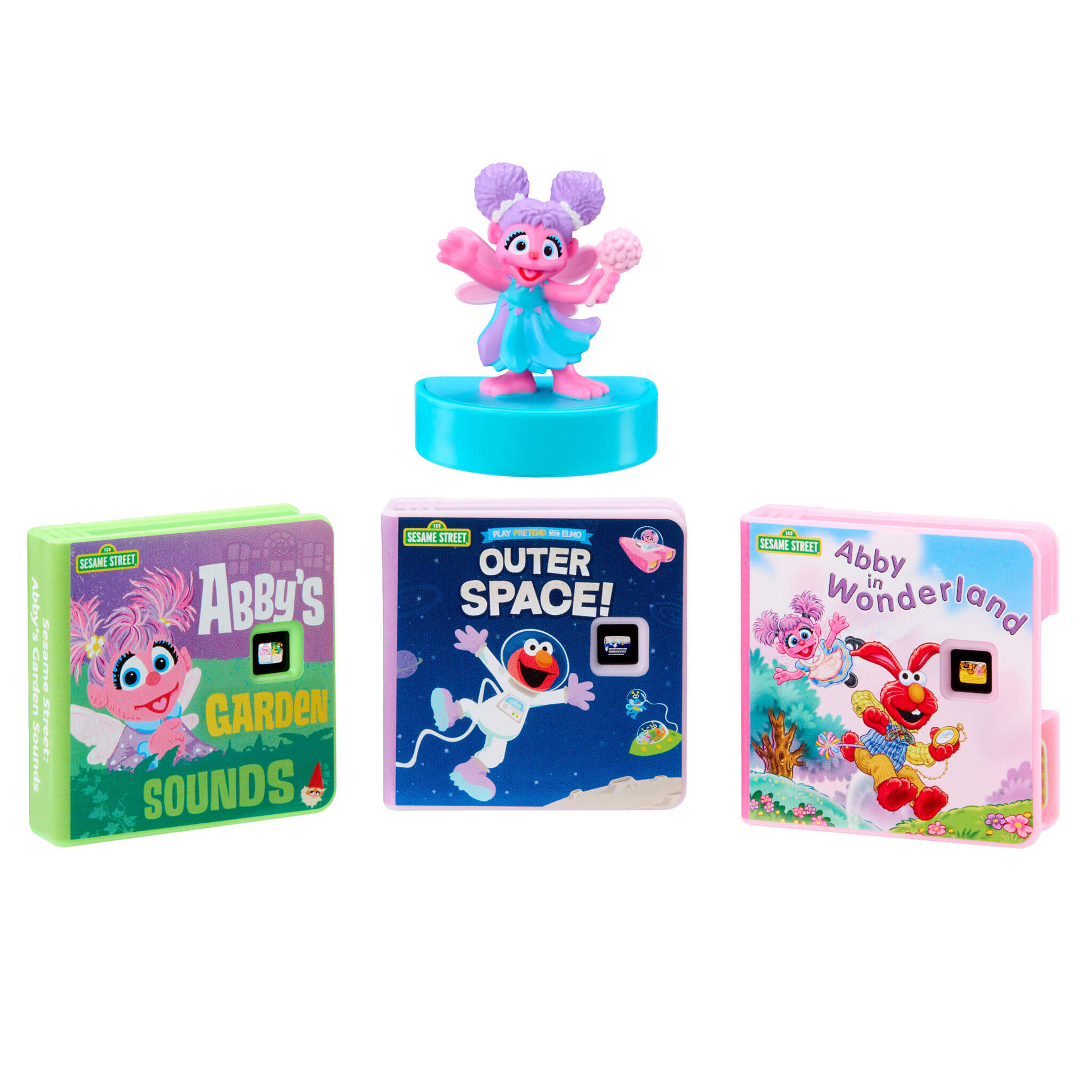Toy figure with books titled 'Abby's Garden Sounds', 'Outer Space!', and 'Abby Wonderland' on a white background.