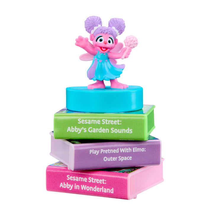 Toy figure on a stack of colorful books with Sesame Street branding
