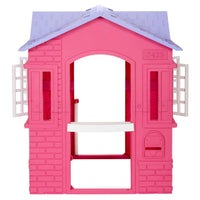 A pink plastic house playset with a light purple roof, white shutters, and a white bench, shown on a solid white background.