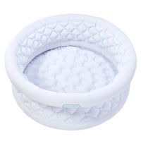 A white inflatable with a quilted diamond-patterned rim and a matching padded interior, shown on a plain white background. A small light blue-green brand label reading 'little tikes' is visible on the front edge.