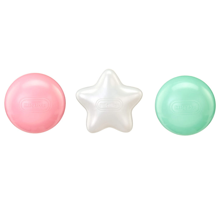 Three balls on a white background: a pink round ball, a white star-shaped ball and a mint green round ball.