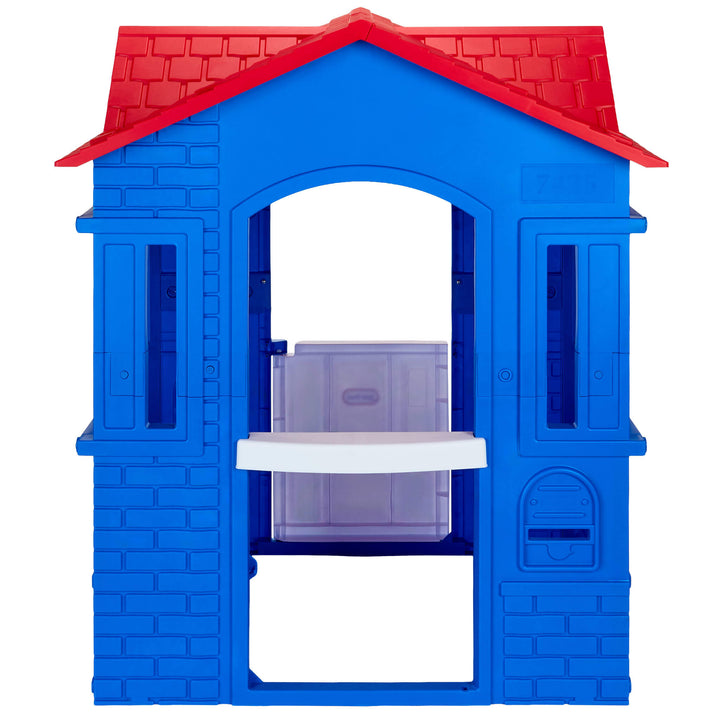A blue plastic toy house with a red roof, featuring an open back with a mail slot isolated on a white background.