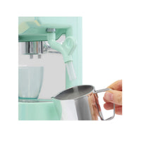 Person using a silver cup to measure liquid from a green machine.