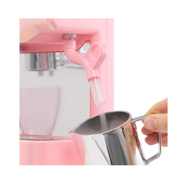 Pink Espresso machine with a silver cup being used to add ingredients.