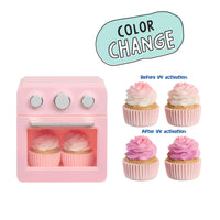 A pink toy oven shown on a white background with a mint-blue 'COLOR CHANGE' label and before/after text. The cupcakes inside and on the right demonstrate a color-changing effect when exposed to UV light.