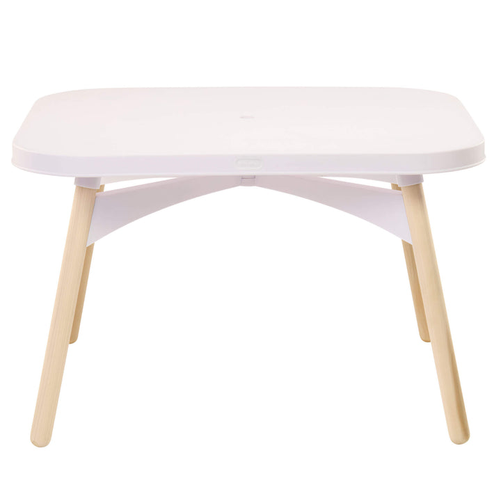 A modern low table with a rounded white top, a white curved support structure underneath, and four light natural wood legs, shown against a solid white background.