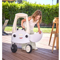 Child opening the door of the coupe car on a brown wood deck