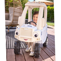 Child sitting inside the truck in an outdoor setting