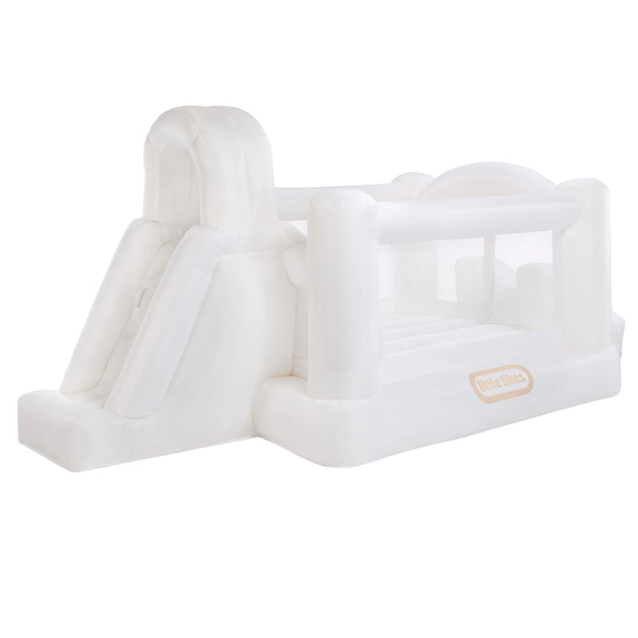 A white inflatable featuring a slide, bounce house, and arch, shown against a plain white background. The brand label 'Little Tikes' is visible on the side.