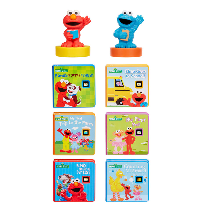 A set of Sesame Street children's mini books, with two character figures standing above each book group: Elmo on a yellow base next to 'Elmo's Funny Friend' and Cookie Monster on a blue base next to 'Elmo Goes to School!'.