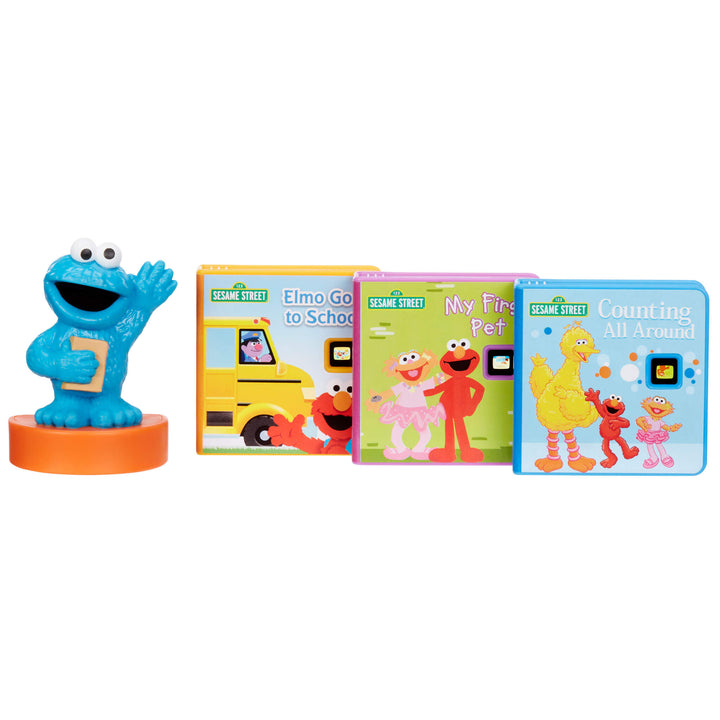 Sesame Street children's sound book set featuring a blue Cookie Monster character toy on an orange base next to four colorful hardcover books: Elmo Go to School, My First Pet, and Counting All Around.