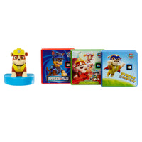 A Rubble figurine on a blue base, alongside three PAW Patrol stories: ‘Rubble to the Rescue’, 'Mission Paw’, and ‘Save the Dinosaurs!’.