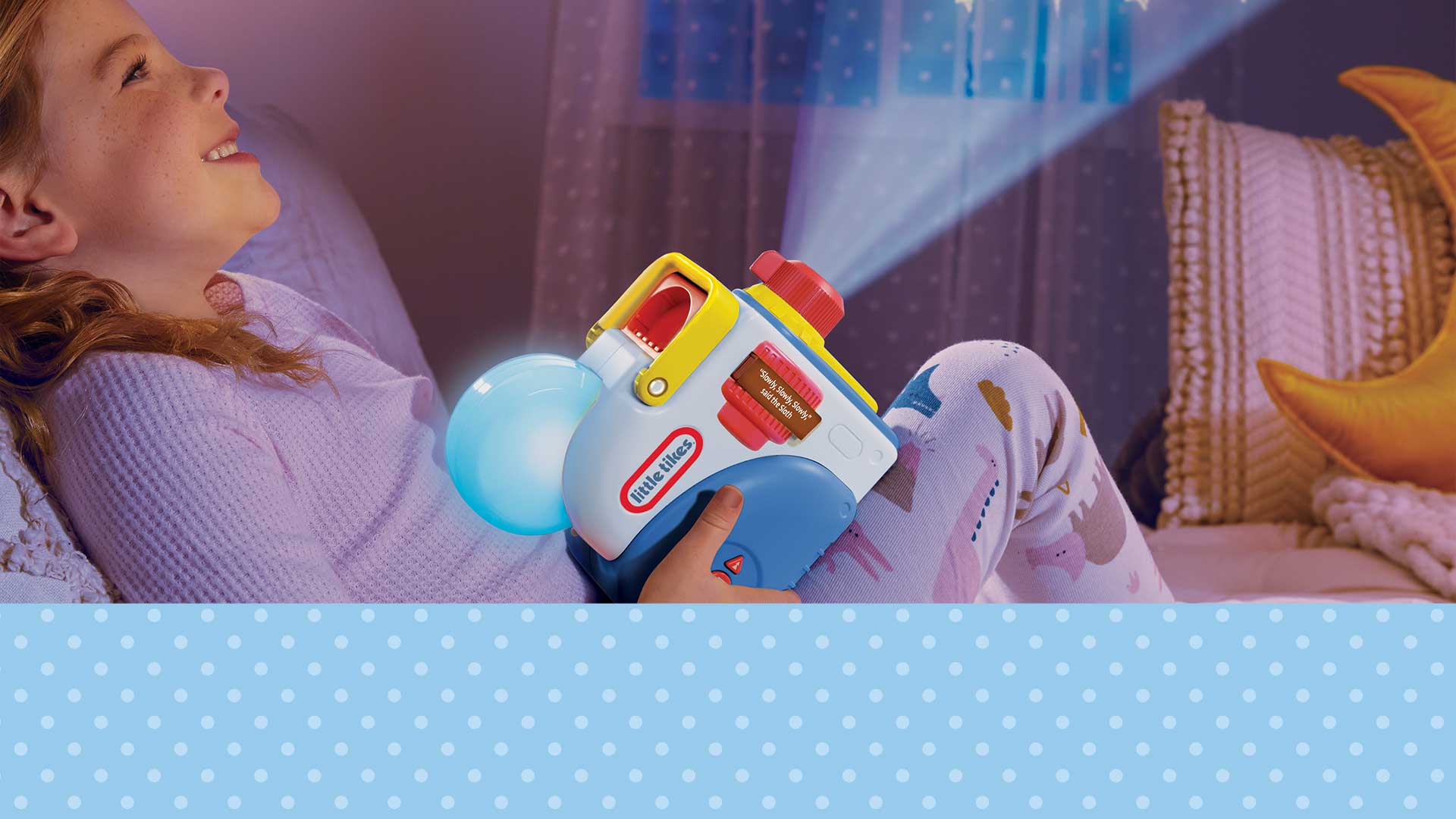 Child holding a toy projector in a bedroom setting